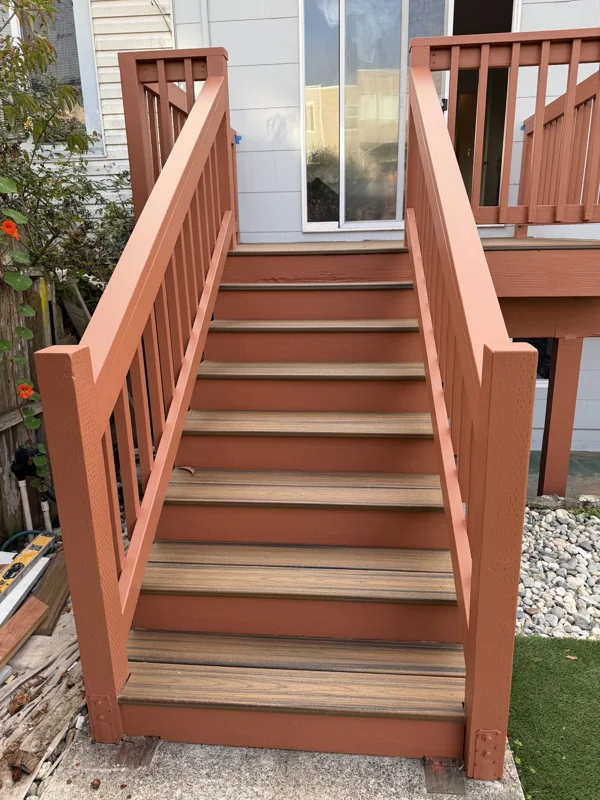 Exterior wood stairs with coordinated railings and contrasting treads.