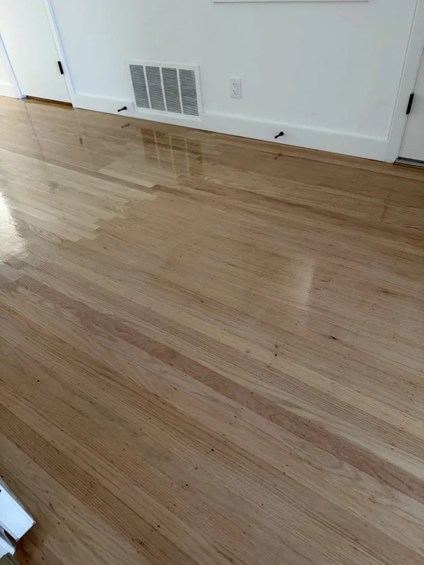 A closer look at the wood floor, edge transitions, and baseboards.