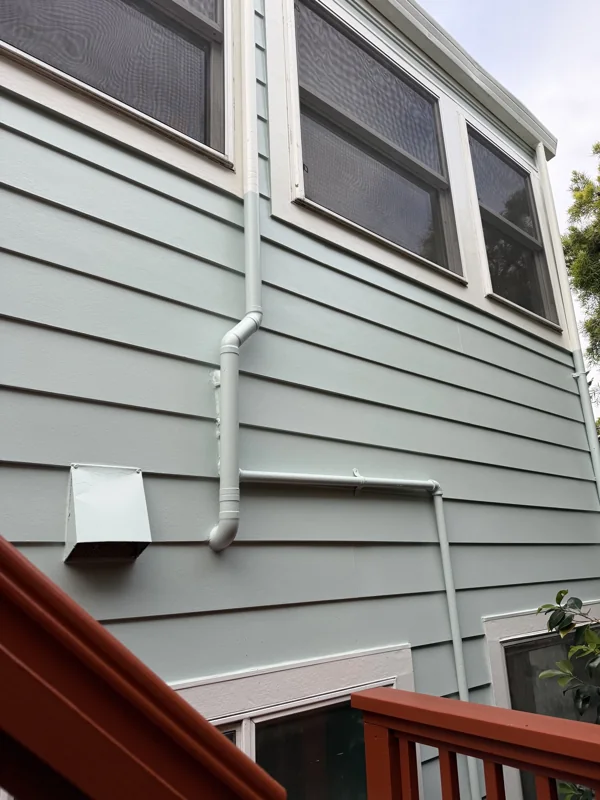 Light-painted lap siding around the windows and stair landing.